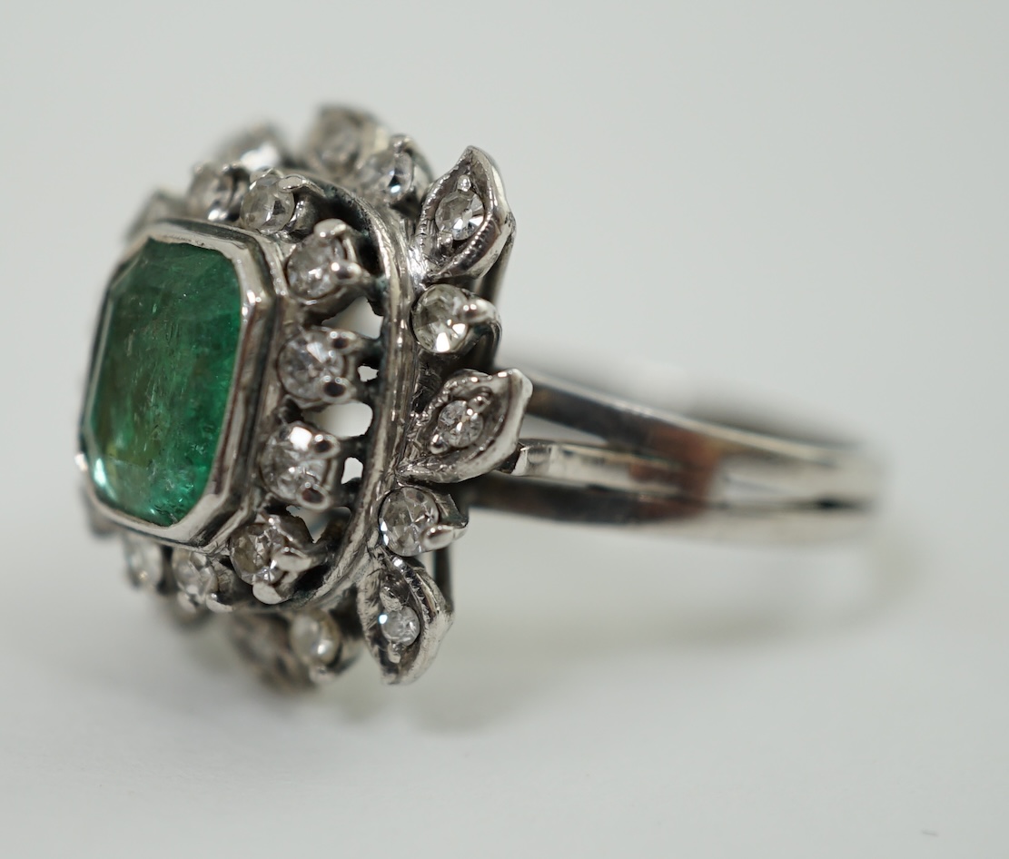 A 1960's white gold, emerald and diamond cluster set dress ring